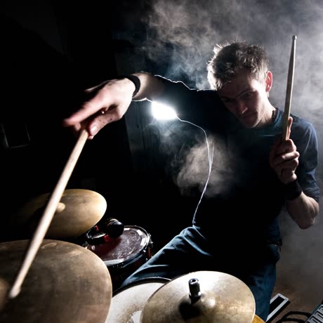 Sam Gardner drumming through stage smoke